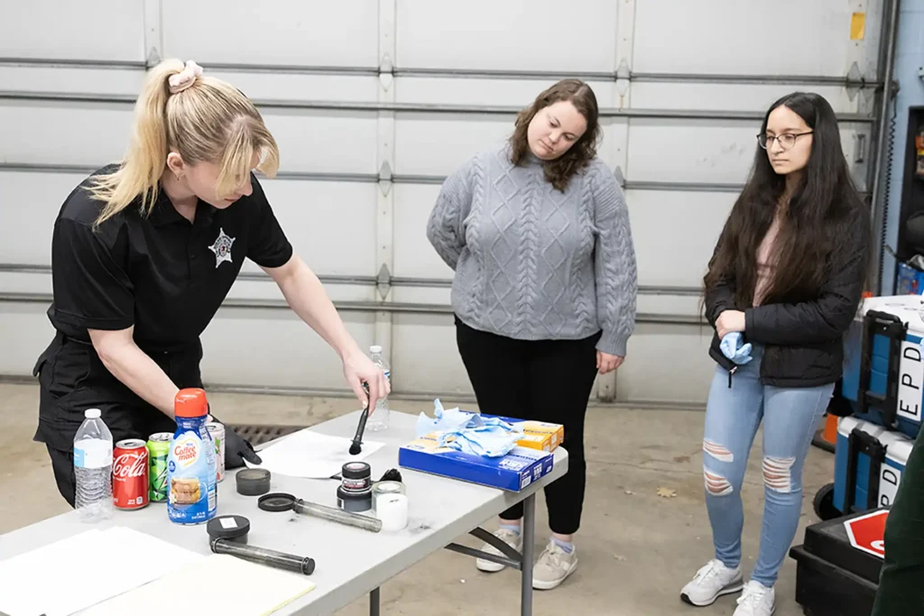 Police Academy Photo 1_W0A5090 Officer Alyssa Aspan instructs
Citizen’s Police Academy students on how to brush crime scene objects and surfaces for fingerprints.